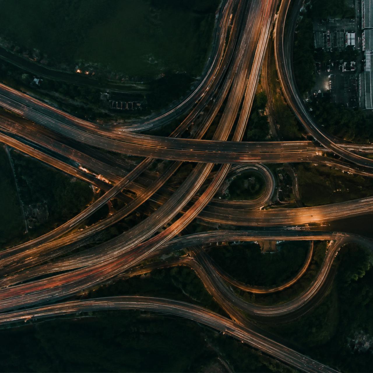 Aerial view of a layered highway interchange at dusk